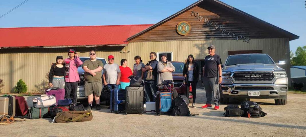 Film students and knowledge-keepers gather in front of Weengusk before setting out on a cultural exchange.