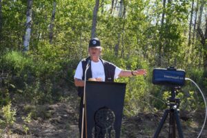 Richard Assinewai opens the 10 am observances with a prayer. photos by Michael Erskine.