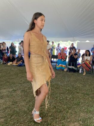 The Wiikwemkoong Fashion Show was a major hit with over six designers exhibiting. The model featured above is wearing a Bruno Henry creation. photo by Bonnie Kogos