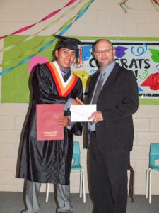 Austin Pangowish is congratulated by principal Mick Staruck upon graduation. Austin is heading to Cambrian College in the fall.