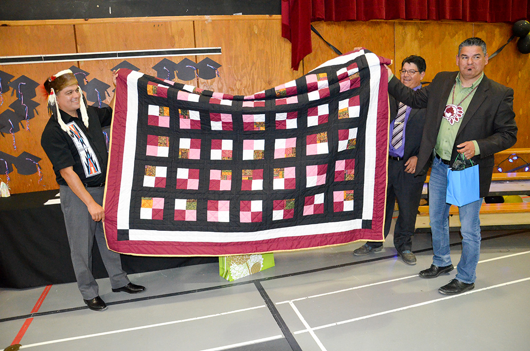 Chief Duke Peltier presents Assembly of First Nations Ontario regional chief Isadore Day with a quilt at the ceremony last week.