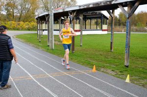 Top high school competitor James Scott crosses the finish line.