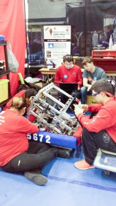 Members of the team work feverishly in the pits to overcome the challenges of getting damaged by the barriers. In photo, from left, are Eileen Letander-Trudeau, Hannah Peltier, Nicholas Wemigwans and Tim Pitawanakwat.