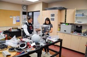 Members of the build team assemble the parts of the FN-STEM team’s robot with meticulous care.  photos by Michael Erskine