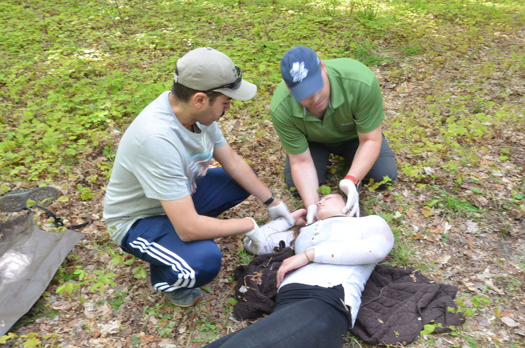 Patient stabilized, the medical students follow up with diagnosis and triage techniques on a Debajehmujig actor simulating a bear attack victim.