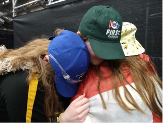 Members of the team share an emotional hug. photo by Daphne Carr