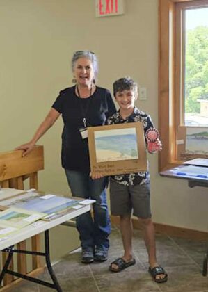 Helen Siksek, organizer of the Manitoulin Plein Air Art Festival is shown with Lack Laporte Alexander, who took both first and second place awards in the youth category.