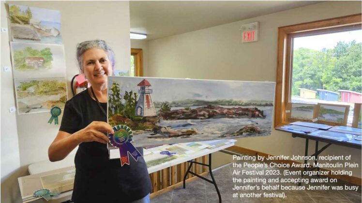 Helen Siksek, organizer of the Manitoulin Plein Air Festival, which was part of Artinfusion weekend, holds a painting by Jennifer Johnson, recipient of the People’s Choice Award.