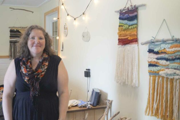 Melanie Hunt with her interactive weaving wall hangings at Feather and Fern Studio in Kagawong.