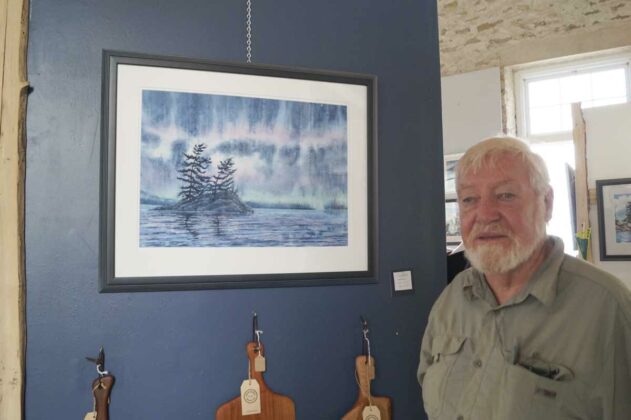 Veteran artist Richard Edwards poses in his Kagawong studio.