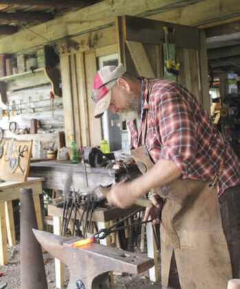 Blacksmith Scott Hartley, works on a snail he completed for display at the art tour. Mr. Hartley operates Happy Camper Forge in Meldrum Bay.