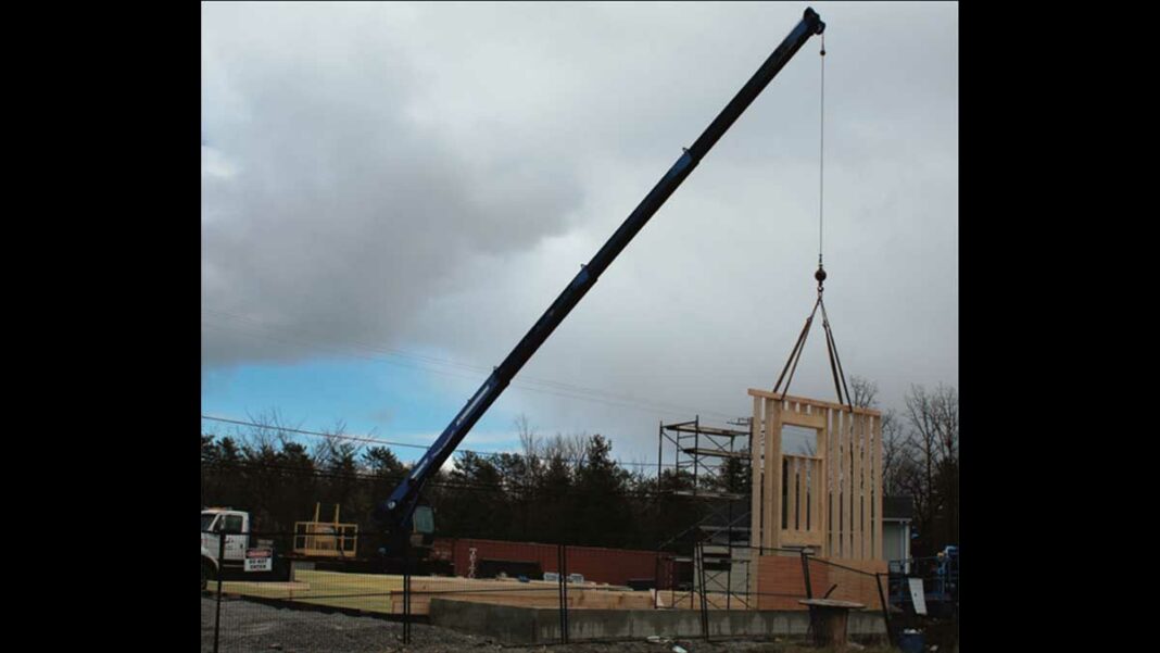 Construction started on the Billings township fire hall last week. A crane hoists a set of wall beams constructed.