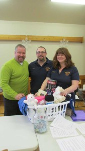 Algoma-Manitoulin MPP Michael Mantha, left in photo, visits Aaron Wright and Apryl Mayer at the Manitoulin Fire Fund table at the Kagawong Winter Fest celebrations.