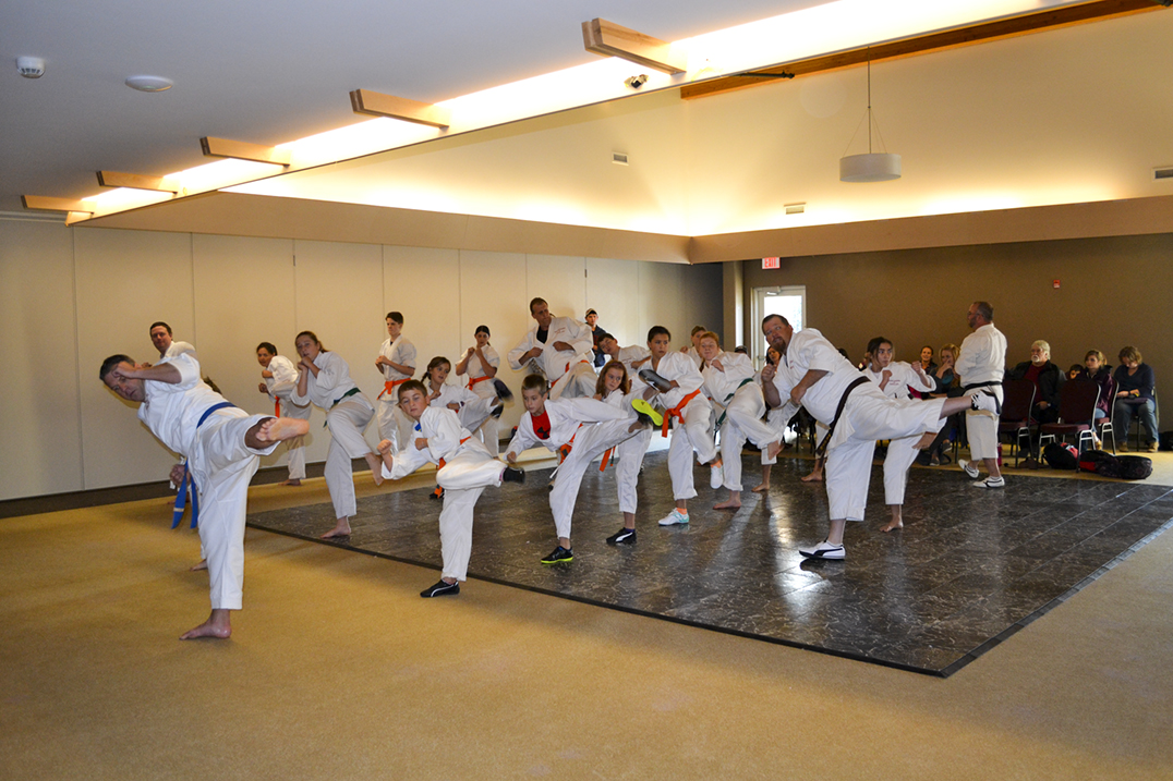 Sempai Mackenzie Cortes and Sempai Brian Boyle lead the class in a kata. photo by Alicia McCutcheon