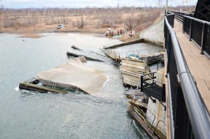 The raging current on Christmas Eve day caused the remnants of the cages to stay stuck at the bridge until winds abated.