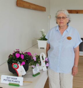 Marie Kirk displays two of her winning entries at the annual Campbell Horticultural Society flower show.