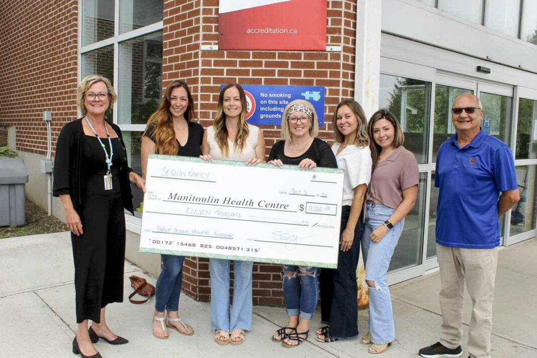 Summer (Chatwell) Seguin, who is originally from Gore Bay, along with members of her family and friends present a donation in the amount of $11,000 to the Mindemoya Hospital chemotherapy department, in honour of her late husband Shawn Seguin. From left, Paula Fields, president and CEO of the Manitoulin Health Centre, Kim Squizzato, Summer Seguin, Courtney Lockyer, Richelle Seguin, Tamara Ferrari and MHC hospital board chair Dennis McGregor.