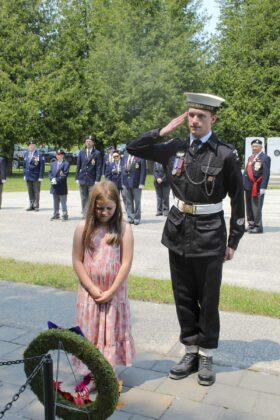 Central Manitoulin Public School student Bella Ferguson-Van Horne, along with cadet Rhys Allison lays a wreath at the Manitoulin Cenotaph children’s memorial.