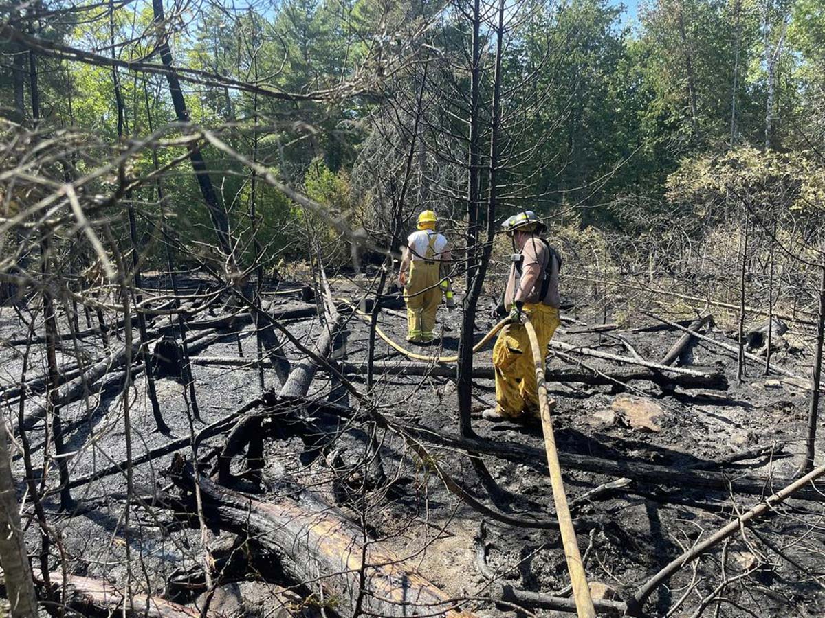 Firefighters with both the Central Manitoulin and Burpee and Mills fire departments work to put out a fire on Scott Road off Union Road on the border area of the two municipalities, this past Saturday. 