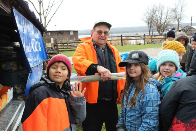 Bill Strain of the Little Current Fish and Game Club introduces the students to a lamprey eel. An invasive species of aquatic parasite that now infests the Great Lakes.