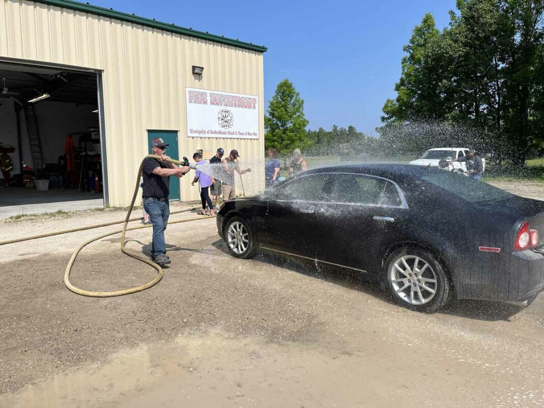 The Gore Bay Fire Department held a very successful car fundraiser earlier this month. Proceeds from the event will go toward the purchase of much-needed equipment for the fire department. In photo is firefighter John Baker.