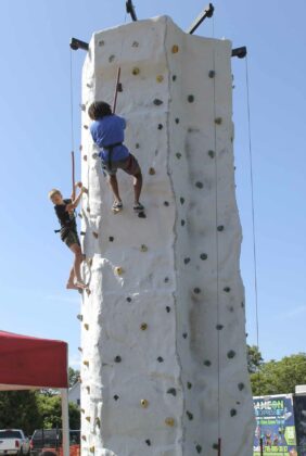 Kids and adults of all age took the challenge of the rock climbing wall, put on by Amaze N Fun.