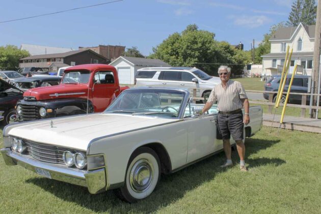 Doug Weddel (shown in photo) and his wife Pat own this 1965 Lincoln, one of the many vehicles on display at the classic car show and shine.