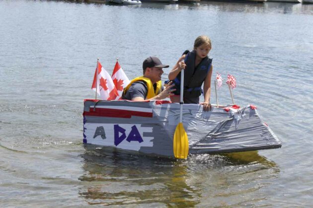 Go Canada! Jamie Osborne and his daughter Avery take part in one of the Cardboard board regatta races.