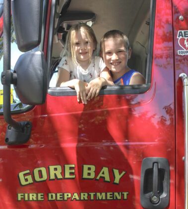 Breleigh and Thomas Haggith of Exeter, Ontario are all smiles as they look on from the drivers seat in the Gore Bay Fire Department truck.