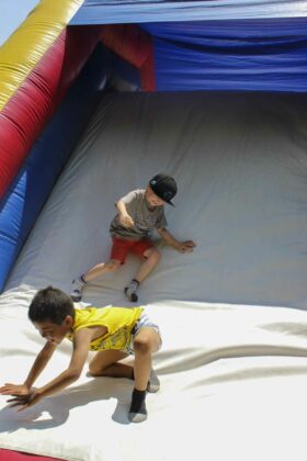 Smiles all around! Kids of all ages loved the many games, including this slide they could go down.