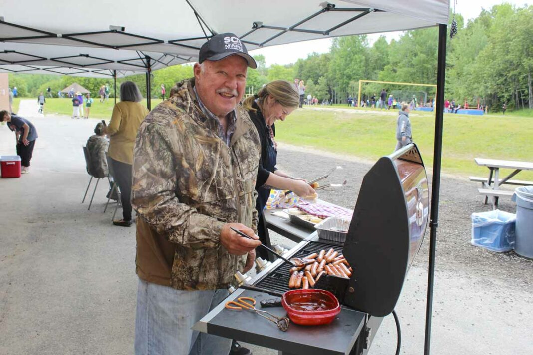 Long-time teacher Ken Wright is seen barbecuing hot dogs at this year’s elementary school track and field championships.