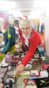 Personal shopper Jacquie Gordon assists a youngster who wants to buy a jewellery item for one of the members of his family at the Kids Shop for Free event held this past Saturday in Mindemoya. 