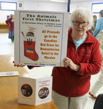 Ruth Johnson of Ottawa displays a book she made, “A Christmas Story in Bobbin Lace,’ depicting animals perspective of the first Christmas, using words and pictures of her bobbin lace.