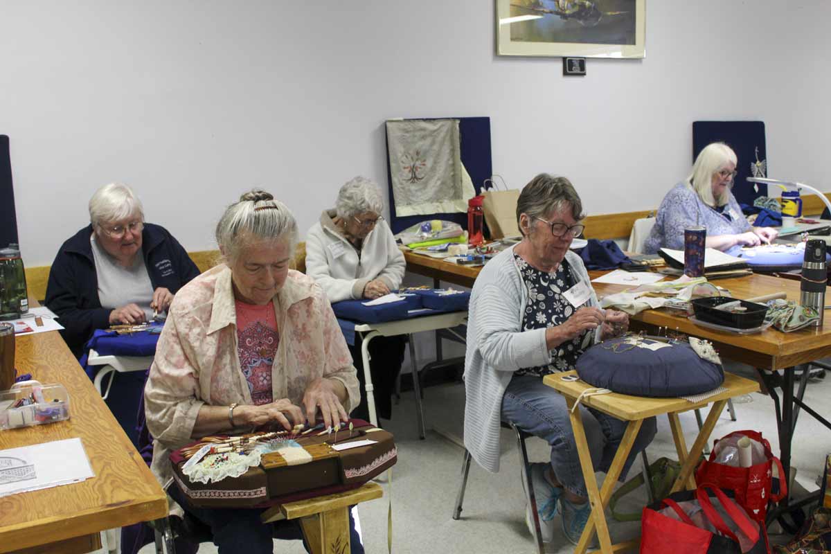 Lacing up a storm! Shown in photo are five of the 29 lacemakers on hand, making various types of lace at Lace Camp