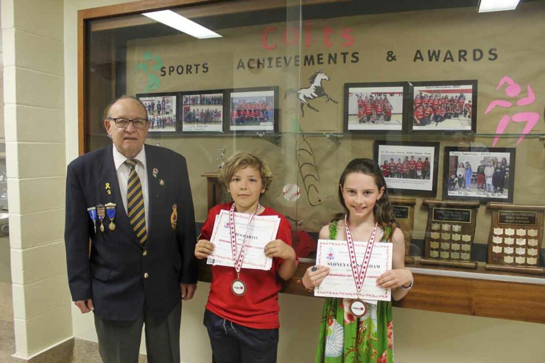 From left are Jim Woods, Royal Canadian Legion Branch 514 youth education chair, James Hartin and Sydney Cunningham.