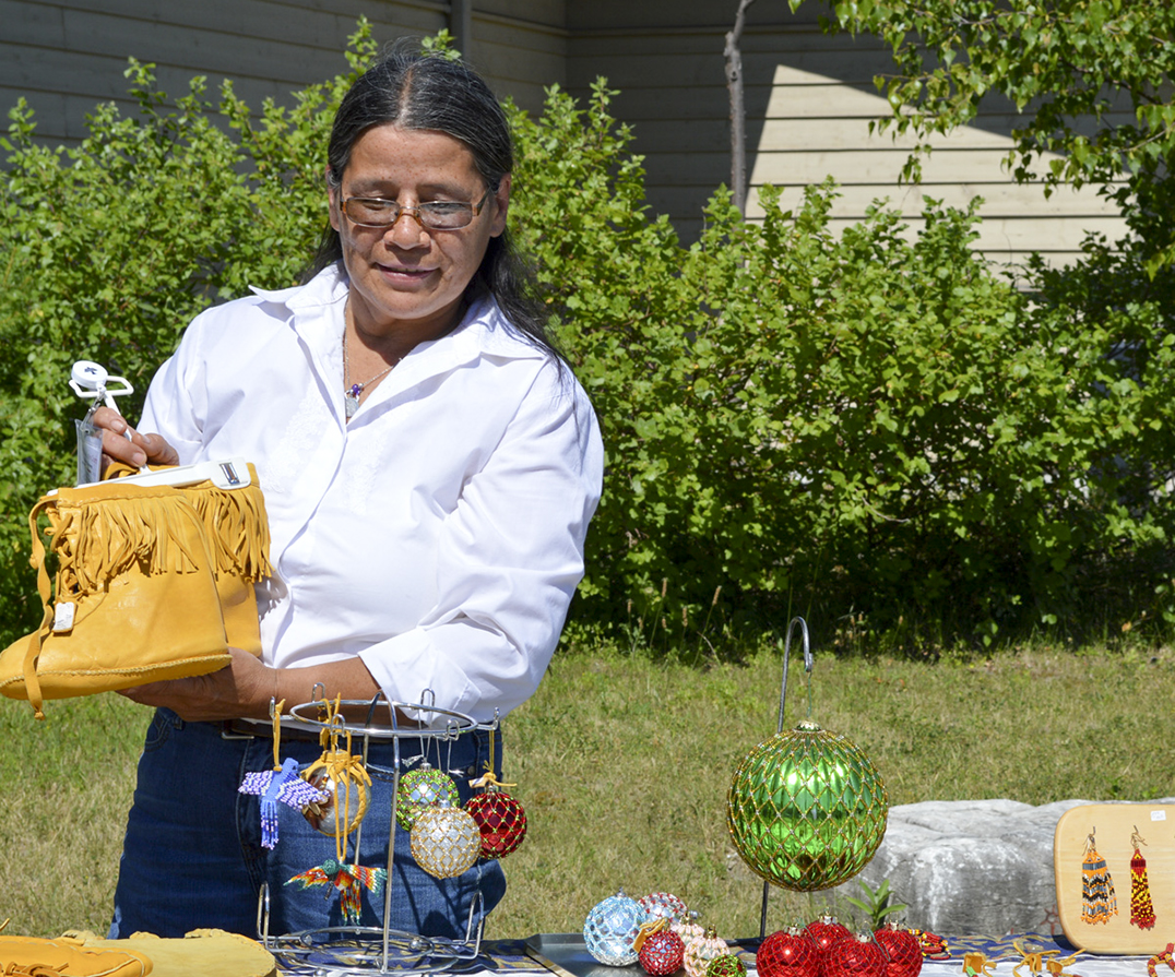 Darlene Bebonang shows off her deerskin moccasins. photos by Jan McQuay