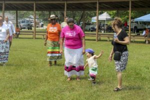 Ogimaa Kwe Linda Debassige and her daughter enjoy the powwow as part of Indigenous Peoples Day in M’Chigeeng. photo by Tom Sasvari