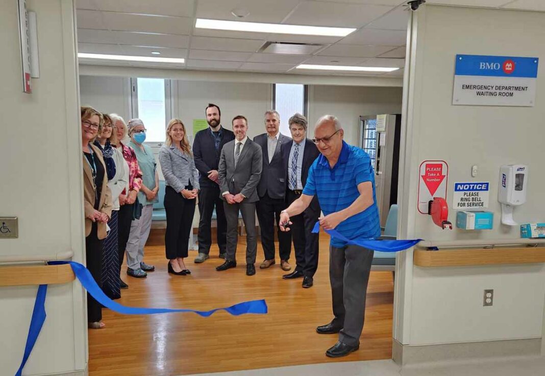 A ribbon cutting ceremony took place at the newly named Bank of Montreal emergency department waiting room in the Mindemoya hospital. BMO representatives along with Manitoulin Health Centre and hospital board members were in attendance at the ceremony. BMO donated $200,000 to the MHC ‘Let’s Emerg Together’ fundraising campaign for the renovation and expansion of the Mindemoya hospital emergency department. In photo left to right is Paula Fields, president and CEO MHC, Kim Cooper, BMO Branch Manager, Little Current, Kimberley Chesney, MHC board member, Dr. Maurianne Reade, president of professional staff, Jennifer Carbone, regional vice-president-personal banking of BMO, Eric Theriault, vice-president of corporate support services and chief financial officer MHC, Joe Bard, BMO assistant market leader, Andrew Brooks, BMO senior relationship manager, commercial banking group, Dino Rocca, BMO market leader private wealth, and Dennis McGregor, chairman of the MHC board, cutting the ribbon.