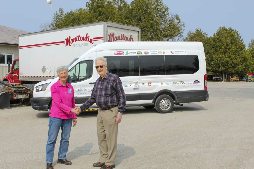 From left, Sandy Cook of The Angel Bus operating committee and Doug Smith of Manitoulin Transport display the new Angel Bus.