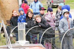 Little Current Public School students get the rundown on the hatchery from Little Current Fish and Game Club President Bill Strain. photo by John Savage