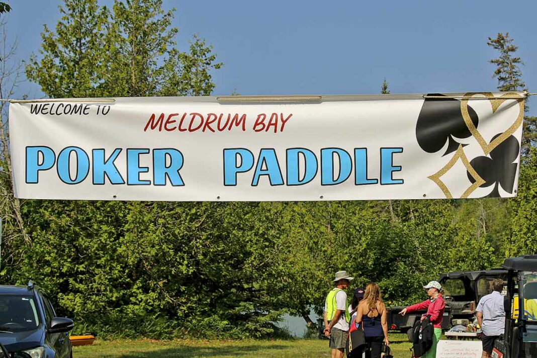 Eager participants arrived early to take part in the annual Meldrum Bay Poker Paddle. There was a record turnout for this year’s event. photo by Paul McAllister