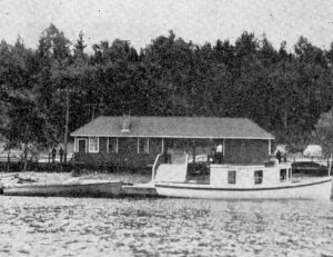 This photo shows the Birch Island station from the water, in 1943. The ramp that local carpenter’s built for US President Franklin Delano Roosevelt for the president’s wheelchair is shown. The vessel at the dock was not one of those used by the president’s party on the visit to Birch Island.