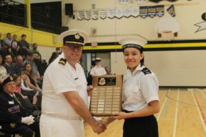 Lieutenant Commander Sylvain Boucher presents the Roger Szydziak Outstanding First Year Cadet Award to Able Cadet Elaina Peltier. photo by Michael Erskine.