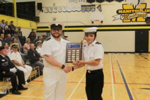 Naval Cadet Daniel Bussieres presents the Manitoulin Navy League Branch Outstanding Second Year Cadet Award to Leading Cadet Austin Flikweert. photo by Michael Erskine.