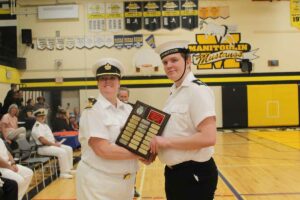 Sub-Lieutenant Tina Davidson, left, presents the outstanding fourth year cadet award to Petty Officer First Class Landon Aelick. photo by Michael Erskine.