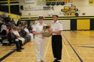 The Bryan Chapelle outstanding citizenship award was presented by 2nd Lt.Tina Davidson, left, to Petty Officer Second Class Samuel Pennings. photo by Michael Erskine.