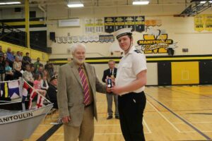 Central Manitoulin Mayor Richard Stephens, left, presented a four-year service medal to Petty Officer First Class Landon Aelick. photo by Michael Erskine.