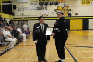 Reviewing Officer Roy Eaton, left, presents the Legion medal of excellence to Chief Petty Officer Second Class Savannah Crack. photo by Michael Erskine.