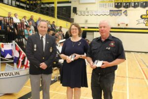 From left, Bob Jewell, president of the Manitoulin Navy League makes a special presentation to Chrisanne and Brad Mackay for their 10 years of dedication and service to RCSCC Manitoulin. photo by Michael Erskine.