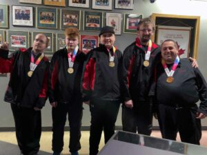 Manitoulin Special Olympians show off their medals following the national qualifying event .